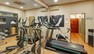 a gym with two treadmills and two ellipticals at Sercotel AB Rivas in Rivas-Vaciamadrid