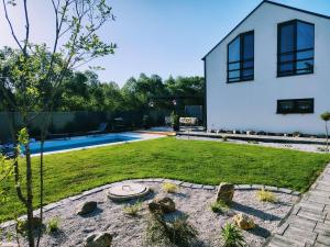 a backyard with a pool and a house at Dovolenkový domček in Sabinov