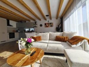 a living room with a white couch and a table at Dovolenkový domček in Sabinov