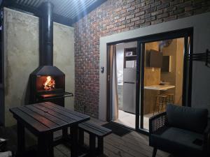 a room with a wooden table and a fireplace at Mon Cheri Clarens in Clarens