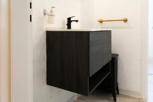 a bathroom with a black sink and a shower at Central Viale in Telese +45 photos