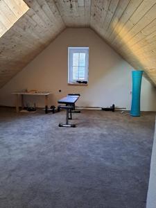 an attic room with a table and a window at Sušice - prázdninový dům in Sušice