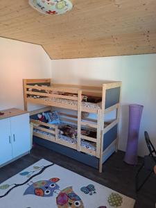 a room with two bunk beds and a ceiling at Sušice - prázdninový dům in Sušice