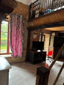 a living room with a desk and a loft at Le Mont Rochard in Sainte-Gemmes-le-Robert