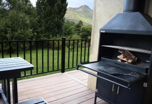 a grill on a deck with a view of a mountain at Mon Cheri Clarens in Clarens