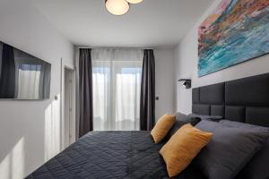 a bedroom with a large bed with yellow pillows at Villa Sunset with swimming pool in Baška +54 photos