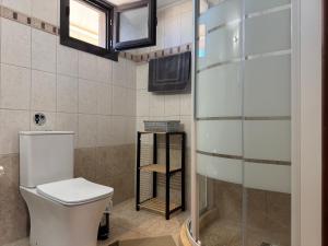 a bathroom with a toilet and a glass shower at My Afytos Balcony in Afitos +75 photos