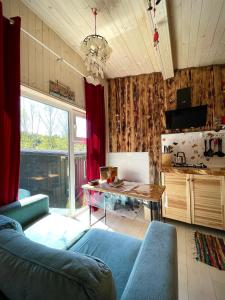 a living room with a blue couch and a table at Апартаменти Smereka in Yablunytsya