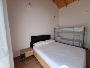 a small bedroom with a bunk bed and a bunk bedouble at Guesthouse Deshnica in Këlcyrë