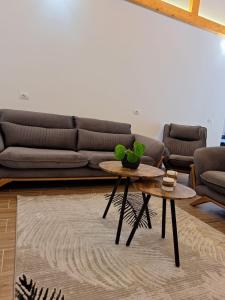 a living room with a couch and a table at Guesthouse Deshnica in Këlcyrë +2 photos