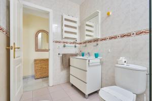 a white bathroom with a toilet and a sink at Blue View in Torrox Costa +14 photos