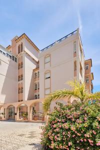 a building with flowers in front of it at Blue View in Torrox Costa