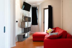a living room with a red couch and a television at Central Viale in Telese