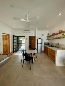 a kitchen with a table and chairs in a kitchen at Casa Arena Cozumel in Cozumel