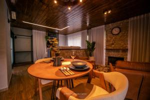 a dining room with a table and a couch at Hotel Fazenda Gabro - Vitra in Apiaí