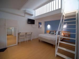 a bedroom with a bed and a bunk room with a ladder at Résidence Thibaud in Toulouse +71 photos