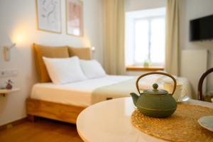 a hotel room with a bed and a tea kettle on a table at BougainVilla in Vonitsa