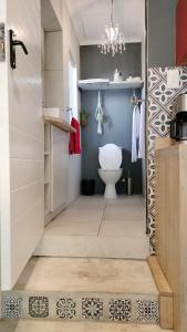 a bathroom with a toilet and a chandelier at Knysna Holiday Cottage in Knysna +40 photos