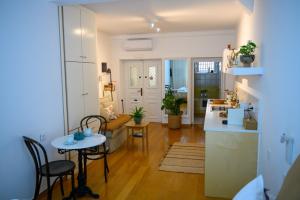 a kitchen and a living room with a table and chairs at BougainVilla in Vonitsa