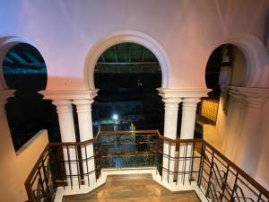 a view from the stairs of a building at night at Umbrella Comfy Stays-Subbu in Madurai +27 photos