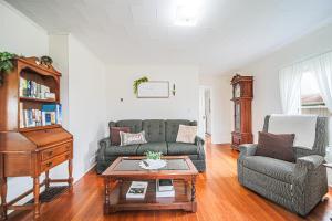 a living room with a couch and a piano at The Wrens Nest in Baltic