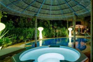 a swimming pool with a hot tub in a resort at Villa CHELSEA in Vilamoura