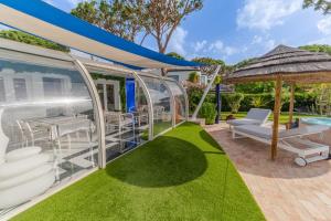 an outdoor patio with a gazebo and grass at Villa CHELSEA in Vilamoura +44 photos