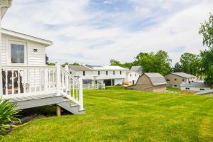 a house with a white staircase in a yard at The Wrens Nest in Baltic