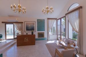 a living room with a couch and a chandelier at Abasolo Clubhouse in La Paz