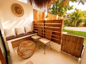 a patio with two chairs and a table at Hiraya Apartments in San Vicente +16 photos