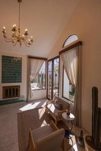 a living room with a couch and a chandelier at Abasolo Clubhouse in La Paz +51 photos