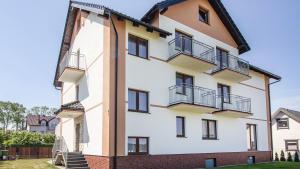 an exterior view of a building with balconies at Flota in Ostrowo