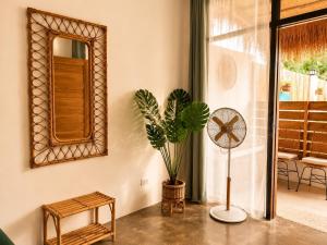 a room with a potted plant and a mirror at Hiraya Apartments in San Vicente