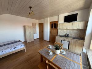 a living room with a bed and a table in it at Flota in Ostrowo