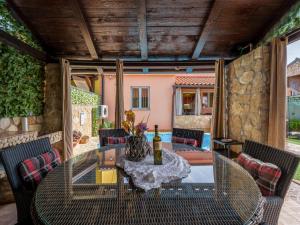 a dining room with a table and chairs on a patio at Holiday Home Ana by Interhome in Šilo