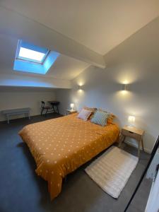 a bedroom with a bed and a skylight at Villa émeraude in Cublac +11 photos