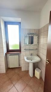 a bathroom with a sink and a mirror and a window at Casa Tassistro in Pareto +10 photos