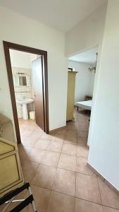 a room with a tile floor and a bathroom at Casa Tassistro in Pareto