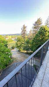 a metal railing on a balcony with trees at Casa Tassistro in Pareto