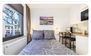 a small bedroom with a bed and a desk at Downtown Apartment in Bonn