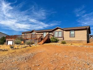 a house in the middle of a dirt field at Ticaboo Lodge in Ticaboo