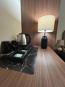 a table with a lamp on top of a counter at Villa Verden in Łomża