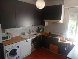 a kitchen with a sink and a washing machine at Modena Sound Suite in Modena
