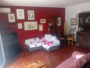 a living room with a bed and a red wall at Modena Sound Suite in Modena
