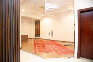 an empty room with a glass wall at Artal Taiba Hotel in Medina