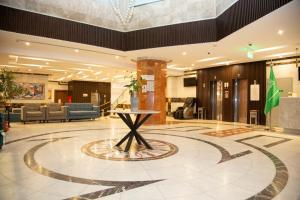 a lobby with a table in the middle of it at Artal Taiba Hotel in Medina +91 photos