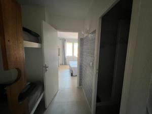 a hallway with a hallway leading to a room with a bedroom at Résidence les pieds dans l'eau in Porto-Vecchio +226 photos