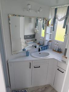 a bathroom with a sink and a mirror at Biały domek in Zastań