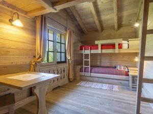 a room with a desk and bunk beds in a cabin at Chalet Chalet Anna by Interhome in Grosotto