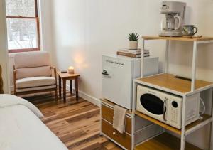 a room with a bed and a microwave on a shelf at Lakeside Heritage Resort in Carp Lake